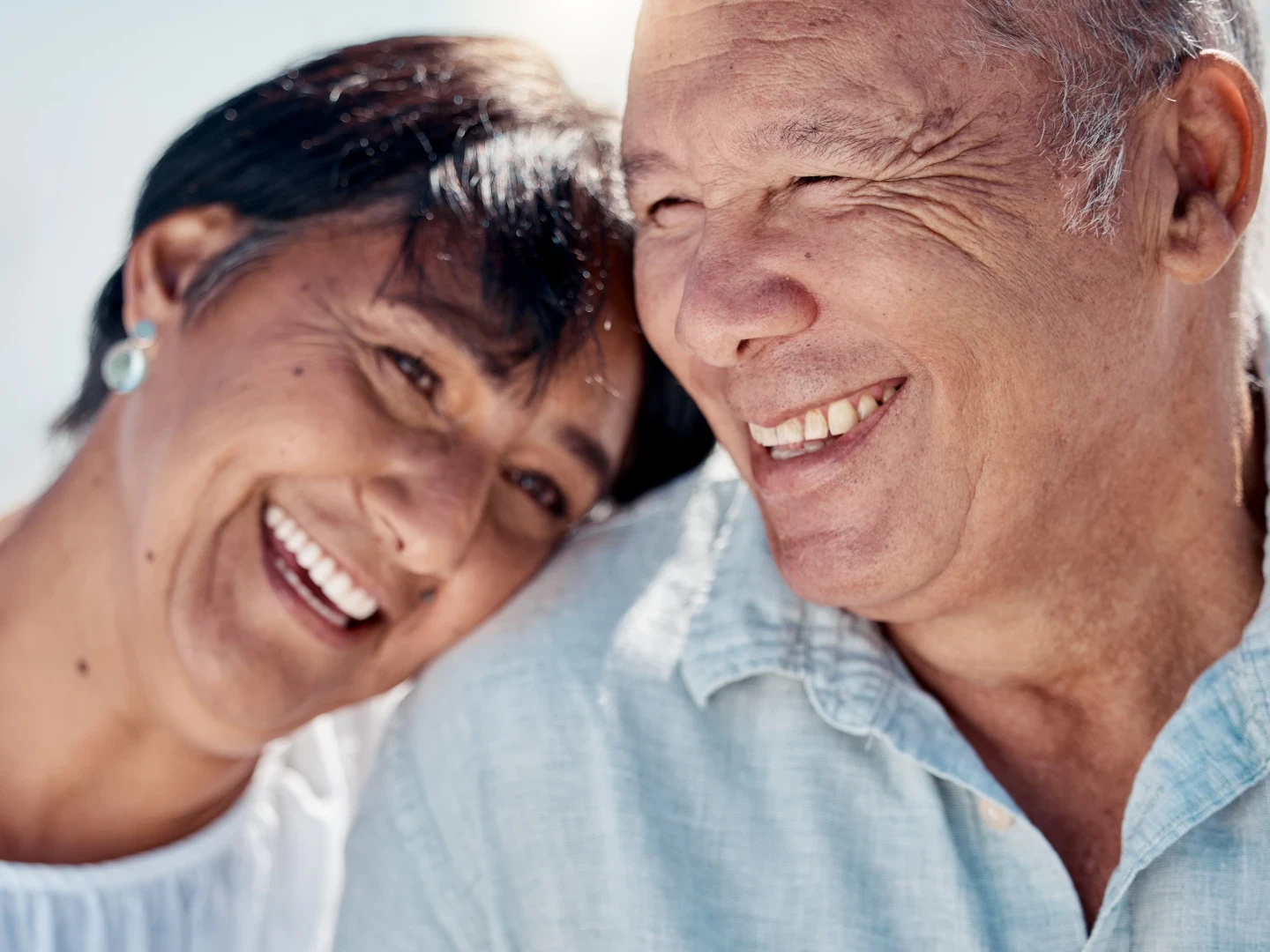 Senior couple smiling in the sunshine